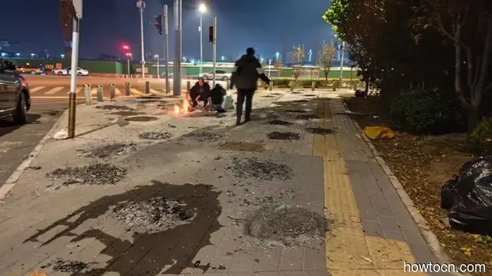 Why do the Chinese burn paper on Tomb Sweeping Day?